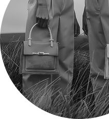 Black and white photo of two people holding handbags symbolizing style and brand identity by Luna360 Media